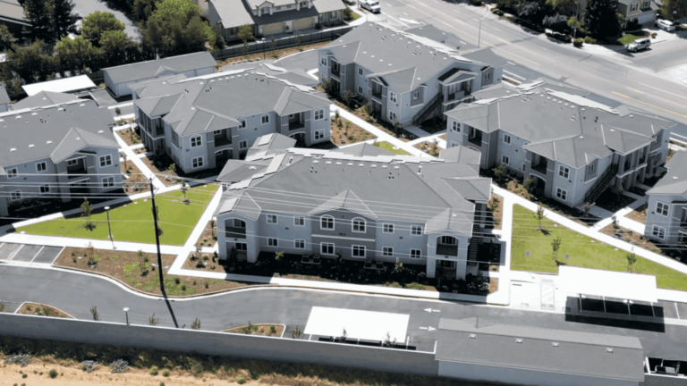 Madelyn court apartment aerial view with 6 buildings with grey two tones, showing the parking and walkways leading to each unit