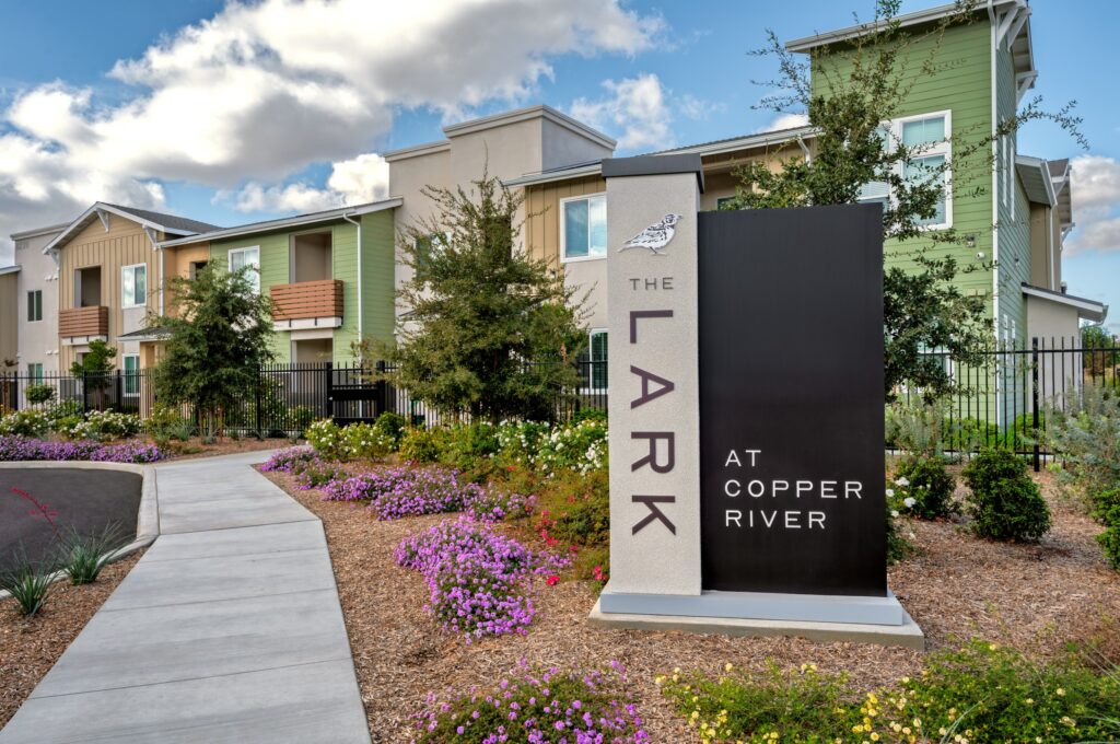 Exterior shot of Lark at Copper River Apartments with Signage on a overcast day