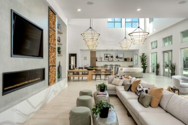 lobby showing fireplace tv viewing area with extended couch, two rows of long tables with bench seating and booths for peak relaxation and focus activity capabilities