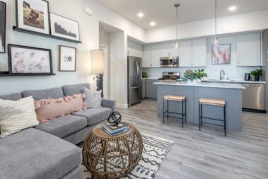 apartment staging view with couch and kitchenette view and open lighting