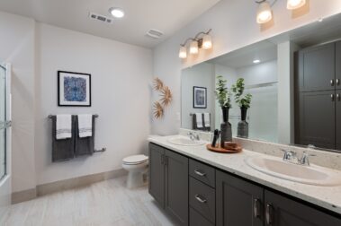 apartment bathroom with two sinks and white painted design with a modern feel