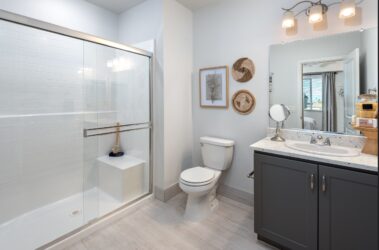 bathroom area in apartment with toilet, modern lighting and minimalistic features